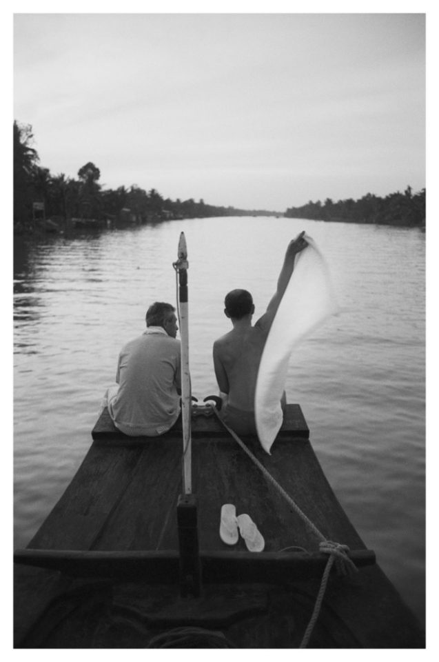 Vietnam 1994 - Couple of friends on a junk. Mekong delta at dusk.
