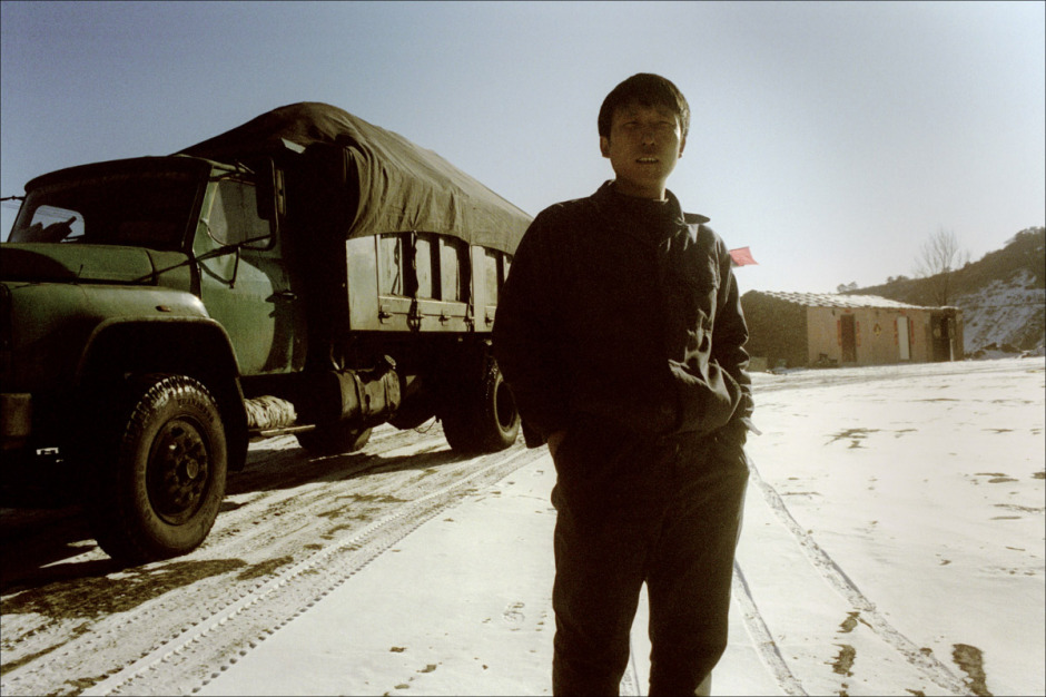China, Datong, 2006 - Chen Guiyin, 25, is a truck driver. He drives 19 tons of coal in his truck, on mountainous roads. "Legally, the limit is 7 tons, but noone observes it. We pay a tax to the inspectors and they let us go. If the law was observed, the coal transport would be paralyzed."He earns 200 euros a month, driving 12 hours a day. he only goes home "when the truck is being serviced".