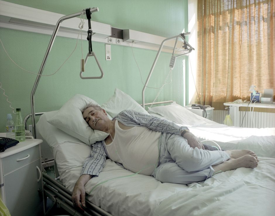 France, Behren lËs Forbach, 2007Nicolas, 58 years old. After 35 years in the mine, he is suffering from silicosis, with 90% of respiratory unsufficiency. Solicosis is a disease caused by the inhalation of silica dust particles, triggering a progressive and irreversible reduction of the respiratory capacity. To stay alive, Nicolas needs 2 litres of oxygen a day, provided by a respirator, 24 hours a day.France, Behren lËs Forbach, 2007Nicolas, 58 ans. AprËs trente-cinq ans au fond de la mine il souffre de la silicose avec 90% d'incapacitÈ pulmonaire. La silicose est une maladie provoquÈe par l'inhalation de particules de poussiËre de silice qui engendre une rÈduction progressive et irrÈversible de la capacitÈ respiratoire. Pour rester en vie Nicolas a besoin de deux litres d'oxygËne par jour fournis par un respirateur, 24 heures sur 24.  © Rip Hopkins / Agence VU