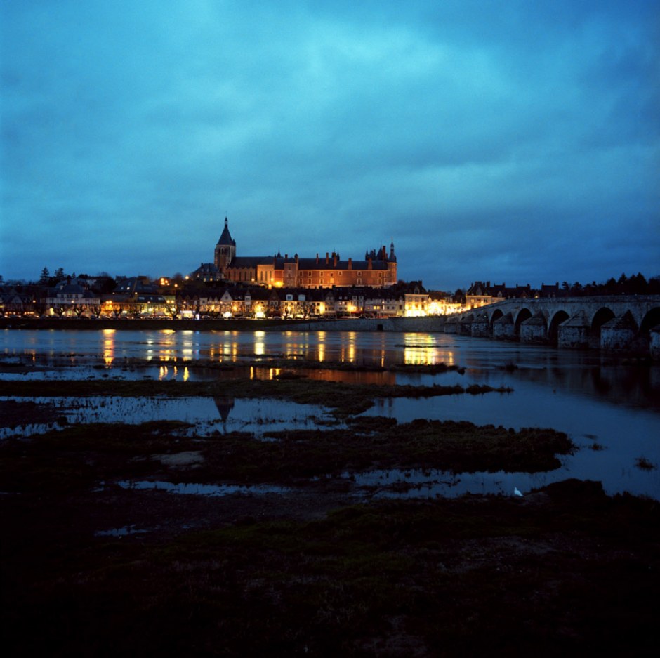 France, Gien, December 2007. Anne de Beaujeu's Castle (XV century), Sainte Jeanne of Arch Church (1940), 12 Arches bridge (XIII century), on the Loire river.