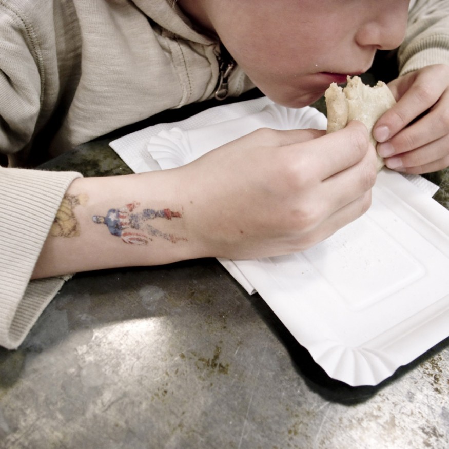 France, Paris, 2009 - Child eating a sandwich.