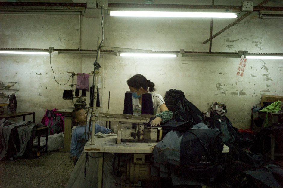 China, Xintang, May 2011 - She works 12 hours a day, seven days a week and have only one afternoon off in a month, on pay day.