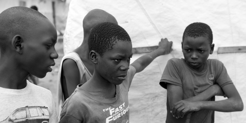 Burundi, Bujumbura, Buterere, IDP camp of Sabe, November 2011Nowa Havyarimana, 15 years old, with his friends at the camp.He lives with his father and brothers in the IDP camp of Sabe. When his mother died, he had to stop going to school. Since then, he helps his father by selling the metal scraps he finds in the streets. In spite of everything, he wants to go back to school. Burundi, Bujumbura, Buterere, IDP camp of Sabe, novembre 2011Nowa Havyarimana, 15 ans, accompagnÈ de ses amis.Il vit avec son pËre et ses frËres dans le camp de deplacÈs de Sabe. Lorsque sa mËre est dÈcÈdÈe, Il a d˚ arrÍter d'aller ‡ l'Ècole.Depuis, il aide son pËre en revendant les dechets mÈtalliques qu'il trouve dans la rue. MalgrÈ tout, il voudrait continuer ‡ Ètudier.Martina Bacigalupo / Agence VU