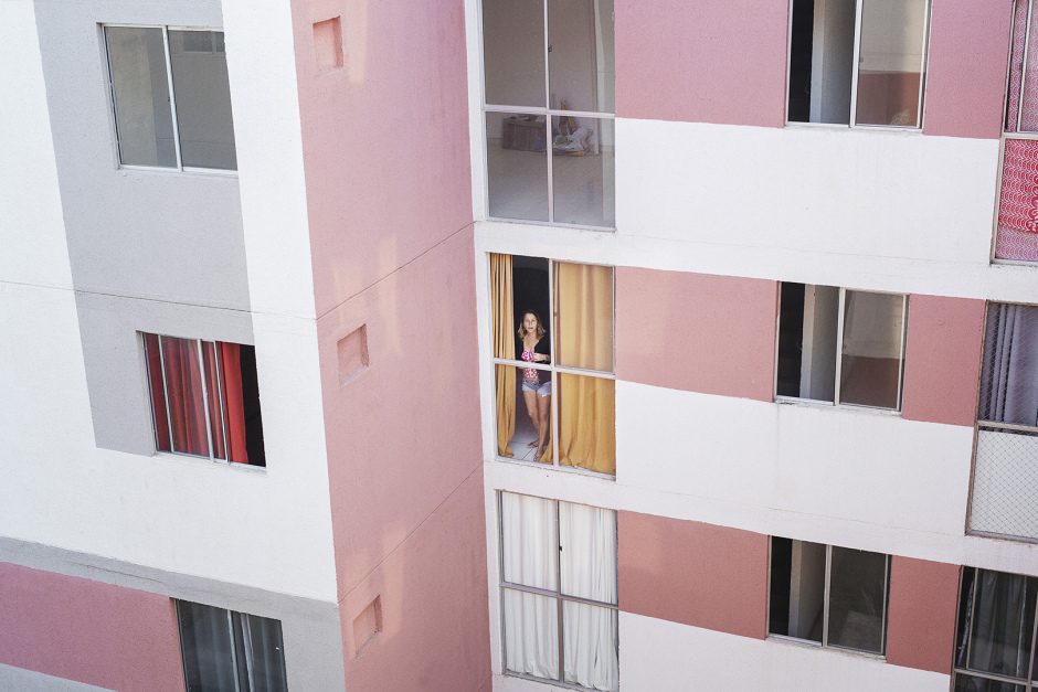 Brazil, Rio de Janeiro, June 27th 2016Julia de Oliveira, 45 ans, caretaker at ColÙnia, at her window.She has a stong character, and she often yells in the block 2's corridor, of which she is in charge. She lives alone and doesn't regret living in the favela. BrÈsil, Rio de Janeiro, 27 juin 2016Julia de Oliveira, 45 ans, gardienne ‡ CÙlonia, ‡ la fenÍtre de son appartement. C'est une femme au caractËre bien trempÈ et dont on entend souvent les rappels ‡ l'ordre sonores dans les couloirs du bloc 2 dont elle a la charge. Elle vit seule et ne regrette pas la favela.Vincent Catala / Agence VU