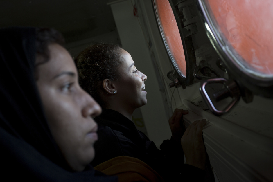 Mediterranean Sea, October 19th, 2017Hasna, 27, and Rajaa, 27 years old, look at the land (Sicilia) in the "shelter" of the Aquarius.Hasna is Maroccan and had left her country two years ago following the economic crisis. She went to find fortune in Lybia with her childhood friend Rajaa. "But, in Lybia, there is no life : militias make life impossible to people We can't go buying some bred without being arrested and getting robbed some money, they can kill you for nothing. In addition, I was working as hairdresser and I earned very few. We had escaped murder but we have seen so many people getting shot in front of our eyes.There were explosions everywhere, somtimes we didn't eat for two day, you don't know if you're gonna live or not, so you don't care about anything... We just wanted to have a simple life, without being afraid of dying every night. So we decided to take the boat. Everybody talk about these boats... We got into it. We saw this mother with her two daughters. I cried, because they are boats of death...But if she leave, even with her little girls, if we are gone, if I left my 6-year-old daughter and left her to my mother, it's because we don't have other choice... We leave our families, our country, everything. Because life over there is just not possible anymore..."Mer MÈditerranÈe, 19 octobre 2017Hasna, 27, et rajaa, 27 ans, regardent la terre-ferme (la Sicile) dans le ?shelter?de l?Aquarius. Hasna est marocaine et a quittÈ son pays il y a deux ans suite ‡ la crise Èconomique. Elle est allÈe chercher fortune en Libye avec son amie d?enfance Rajaa. ?Mais en Libye il n?y a aucune vie : les milices rendent la vie impossible aux gens. On ne peut pas aller acheter du pain sans Ítre arrÍtÈes et se faire voler de l?argent, ils peuvent te tuer pour rien. En plus je travaillais comme coiffeuse et je gagnais trËs peu. On a ÈchappÈ au meurtre mais on a vu tellement de gens se faire abattre devant nos yeux.Il y avait des explosions de partou