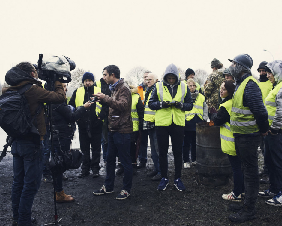 France, Albert, 1st December 2018 - François Ruffin, deputy of La France Insoumise (Left wing party), surrounded by yellow vests, interviewed during the filtering blockade of the roundabout at Albert's entrance to the Somme.