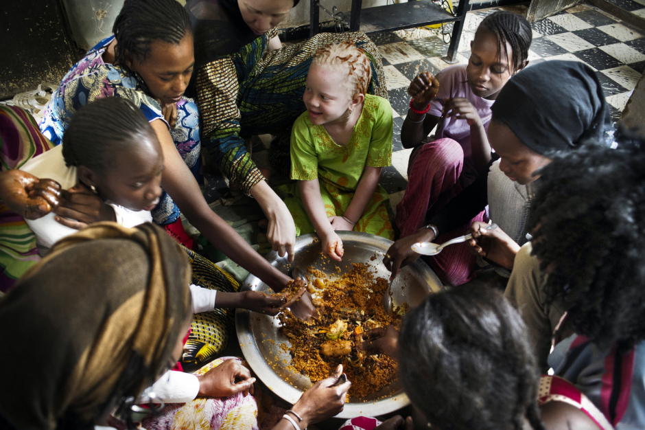 Senegal, Thiès, 28 March 2012Fabimeta Diop (in green), the daughter of Mohamadou Bamba Diop, president of the National Association of Albinos from Senegal (ANAS), eating a meal with the women living in the house.Sénégal, Thiès, 28 mars 2012Fabimeta Diop (en vert), la fille de Mohamadou Bamba Diop, président de l'Association Nationale des Albinos du Sénégal (ANAS), déjeune avec les femmes habitant la maison.Michael Zumstein / Agence VU