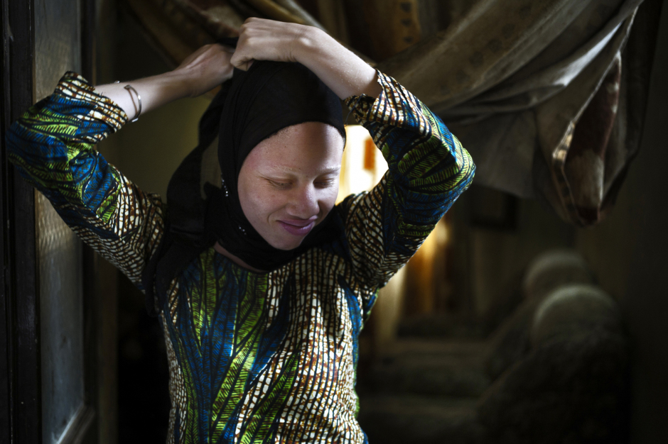 Senegal, Thiès, 28 March 2012Mame Penda Diallo, 22 years old, arranging her veil in the house of Mohamadou Bamba Diop, president of the National Association of Albinos from Senegal (ANAS).Sénégal, Thiès, 28 mars 2012Mame Penda Diallo, 22 ans, ajuste son voile dans la maison de Mohamadou Bamba Diop,  président de l'Association Nationale des Albinos du Sénégal (ANAS).Michael Zumstein / Agence VU