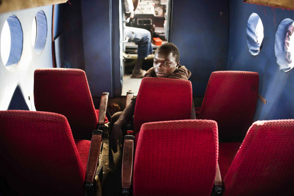 Central African Republic, Bangui, 08 December 2013Almost 10 000 people, most of them christian, took refuge near the airport of Bangui, fleeing from the clashes between the soldiers of the former-Seleka and the Anti-Balaka militiamen who came in to take the capital.Fabrice is posing inside an abandonned aircraft.RÈpublique Centrafricaine, Bangui, 08 dÈcembre 2013PrËs de 10 000 personnes (majoritairement chrÈtienne), craignant les affrontements entre soldats de l'ex Seleka et milices Anti Balaka venues attaquer la capitale, sont venues se rÈfugier prËs de l'aÈroport.Fabrice pose dans la cabine d'un avion abandonnÈ.Michael Zumstein / Agence VU