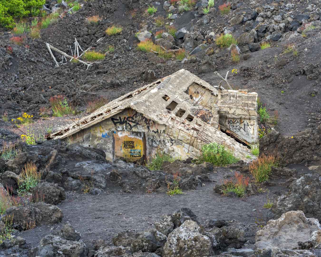 Italy, Sicily, 28 May 2025 - Abandoned house caught in lava