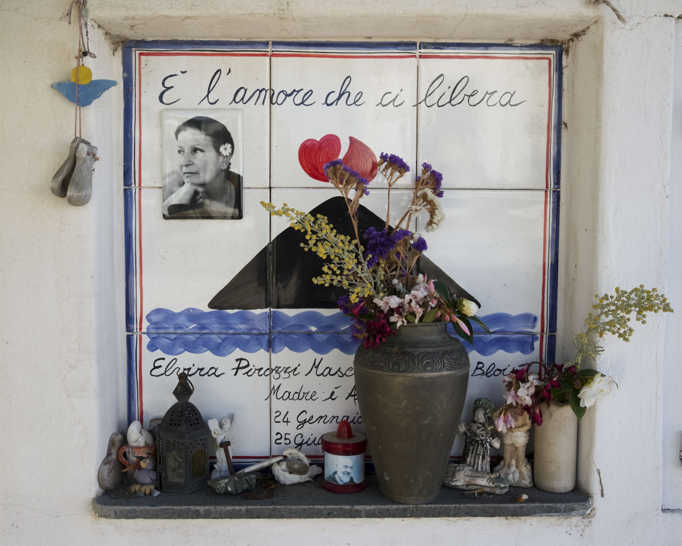 Italy, Stromboli, 1 June 2025 - Detail of a grave decorated with a painting of Mount Stromboli